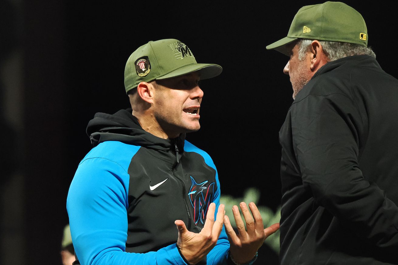 Miami Marlins manager Skip Schumaker (55) questions the call to first base umpire Hunter Wendelstedt (right) during the eighth inning against the San Francisco Giants at Oracle Park.