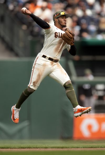 San Francisco Giants second baseman Thairo Estrada (39) leaves his feet to throw out Miami Marlins left fielder Bryan De La Cruz at first base during the seventh inning at Oracle Park.