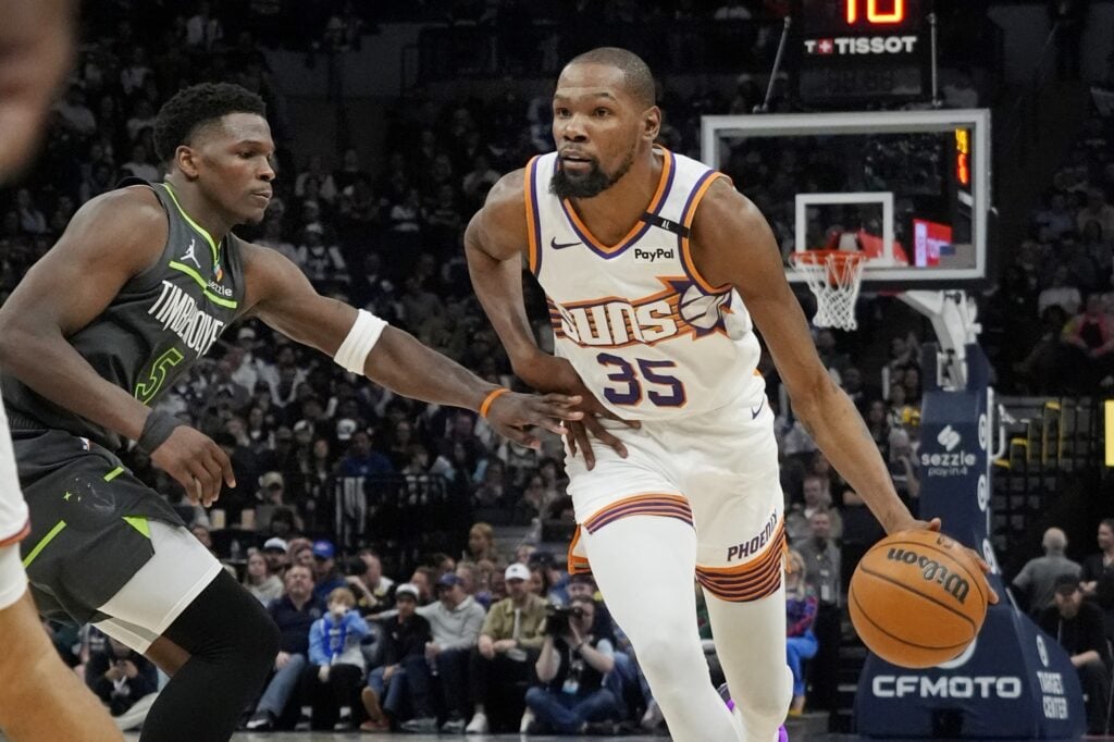 Mar 28, 2025; Minneapolis, Minnesota, USA; Phoenix Suns forward Kevin Durant (35) brings the ball up as Minnesota Timberwolves guard Anthony Edwards (5) defends him in the fourth quarter at Target Center. Mandatory Credit: Bruce Kluckhohn-Imagn Images