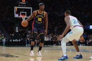 Golden State Warriors forward Jimmy Butler III (10) dribbles the basketball as Miami Heat forward Haywood Highsmith (24) defends during the first quarter at Kaseya Center.